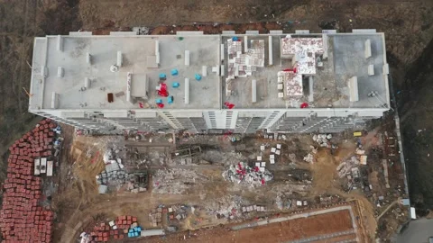 A top-down aerial view of the construction site of a residential building in the Stock Footage 168321190