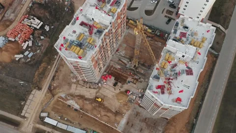 A top-down aerial view of the construction site of residential buildings in the Stock Footage 168322409