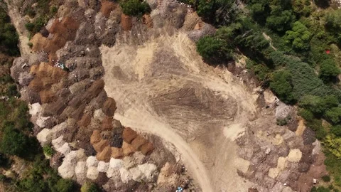 Top-Down Aerial View of a Construction Site with Soil Piles and Dirt Road Stock Footage 345144169
