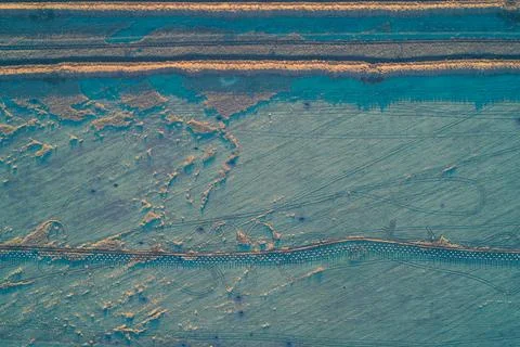 Top-down aerial view of a continuous defense line featuring parallel anti-tank Stock Photos