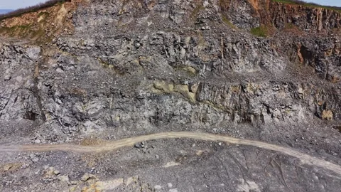 Top down aerial view of conveyor belts at granite quarry Stock Footage 338222046