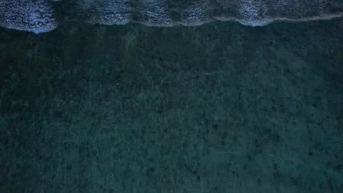 Top down aerial view of crashing ocean waves, drone is flying towards deep water Stock Footage 256219635