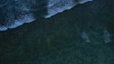 Top down aerial view of crashing ocean waves, drone is slowly hovering in the Stock Footage 256456226