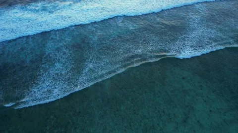 Top down aerial view of crashing ocean waves, drone is slowly hovering in the Stock Footage 256456562