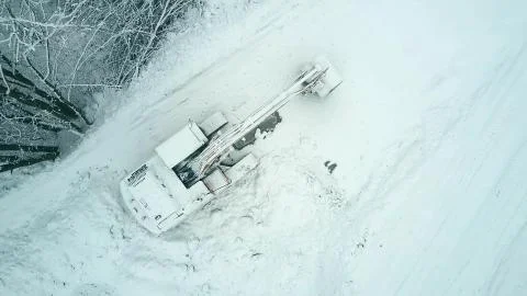 Top down aerial view of a crawler excavator in the snow Stock Photos