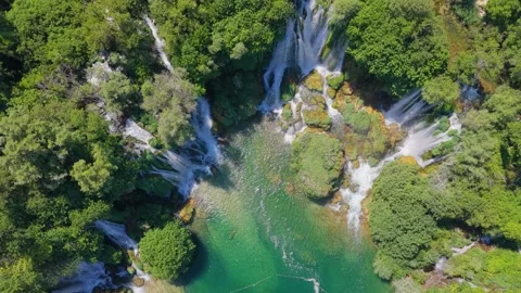 Top down aerial view of crystal clear river flowing beneath spectacular wat.. Stock Footage 340503578