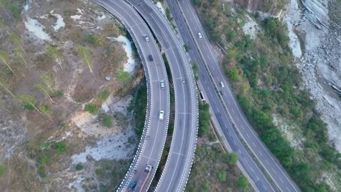 Top-down aerial view of curved road infrastructure. Stockbeeldmateriaal 335645288