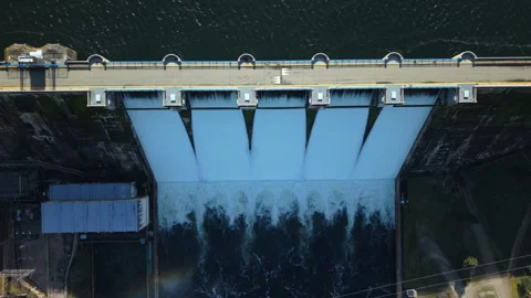 Top down aerial view of a dam releasing a powerful torrent of water Video stock 328355913