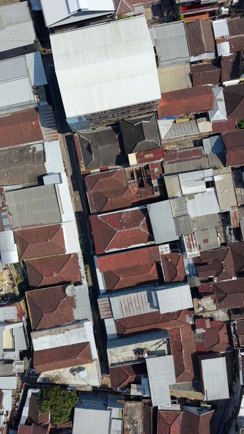 Top-down aerial view of dense residential rooftops in Malang, Indonesia Stock Footage 345396506