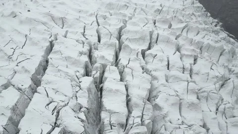 Top-down aerial view detailing the deep parallel fractures and sheer icy chasms Stock Footage 342661734