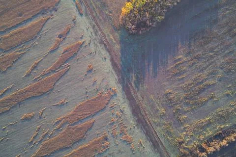 Top-down aerial view of a dramatic diagonal division between two textured Foto stock