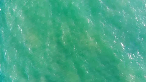 Top down aerial view drone flying over surfer falling into water. Stock Footage 109344326