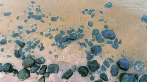 Top down aerial view from drone of calm sea waves crashing and foaming on rock Stock-Footage 143198318