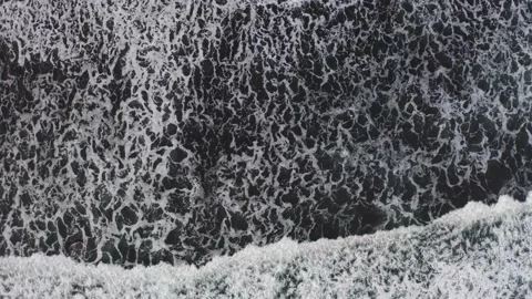 Top down aerial view from drone of volcanic black sand beach Stock Footage 231382128