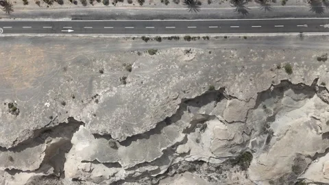 Top Down Aerial View of Dry Canyon with Road in Arid Landscape Video stock 328661819