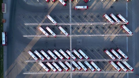 Top down aerial view of electric buses charging, parking and driving at fleet Stock Footage 305655310