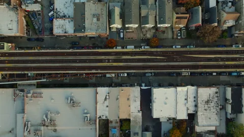 Top down aerial view of elevated train tracks and rooftops, ProRes 422HQ footage Stock Footage 331357307