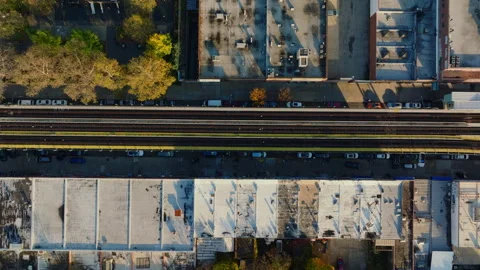 Top down aerial view of elevated train tracks and rooftops, ProRes 422HQ footage Stock Footage 331357454