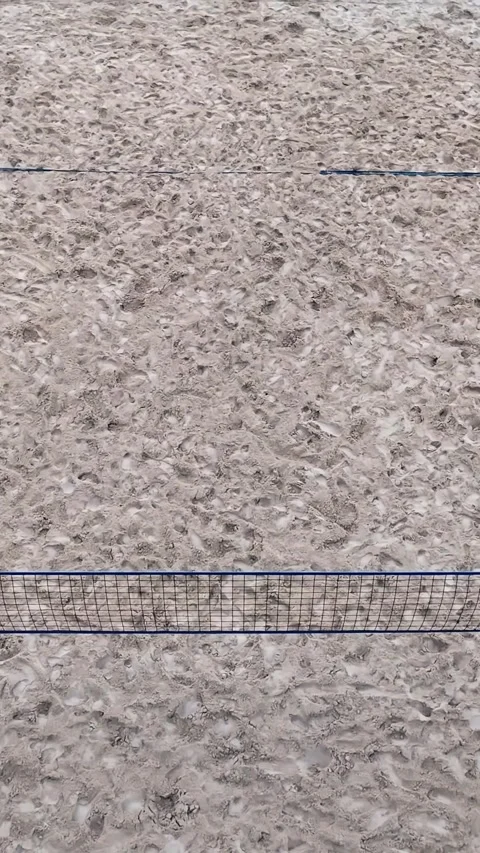 Top-down aerial view of an empty sand volleyball court with a central net and Video stock 347916074