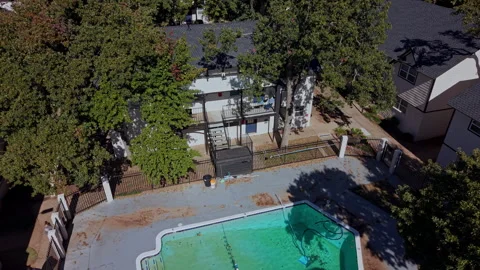Top-down aerial view of a fenced pool at a multifamily housing complex Stock Footage 340925577