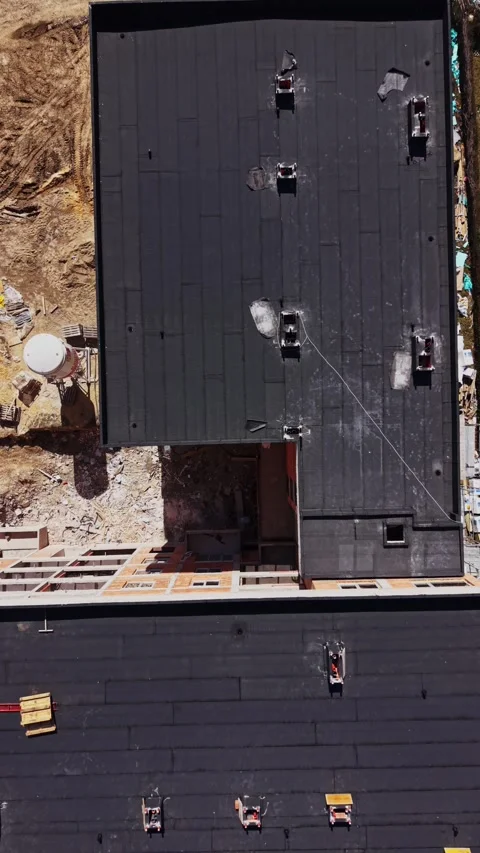 Top down aerial view of flat roofs and construction site Stock Footage 338187728