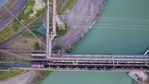 Top down aerial view following a freight train loaded with bulk material Video stock 342394878