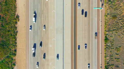 Top down aerial view of freeway traffic with cars moving in parallel lanes Stock Footage 325411534