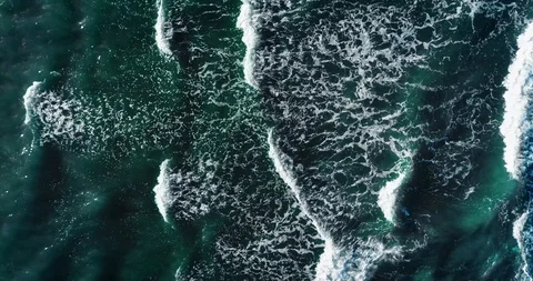 Top down aerial view of giant ocean waves crashing and foaming. UHD. Slow motion Video stock 123815772