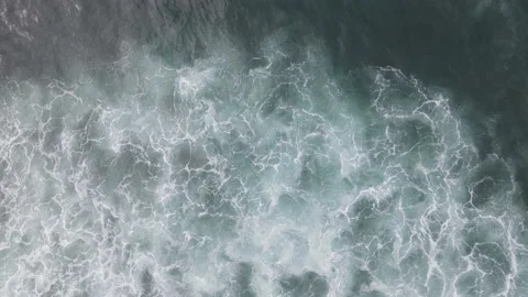 Top down aerial view of giant ocean waves crashing and foaming Stock Footage 168049611