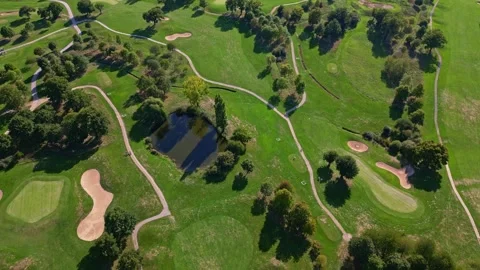 Top down aerial view of a golf course with paths and ponds Stock Footage 328645634