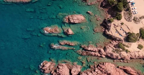Top down aerial view of granite rocks in turquoise Mediterranean water Stock Footage 348196948