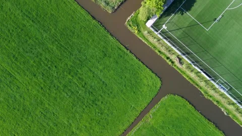 Top-down aerial view of a green sports field with white markings Stockbeeldmateriaal 310237310