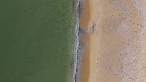 Top Down Aerial View of Green Sea and Sandy Beach Stock Footage 325292599