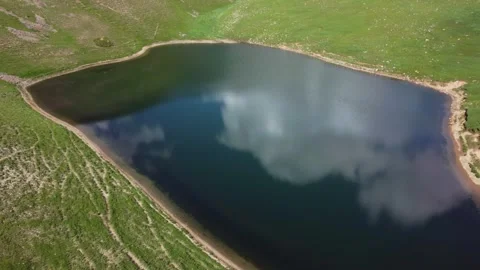 Top down aerial view of heart shaped alpine lake in Kazakhstan Видео 337201484