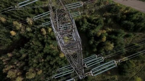 Top-down aerial view of high voltage power pylon over forest 库存影片 348623548