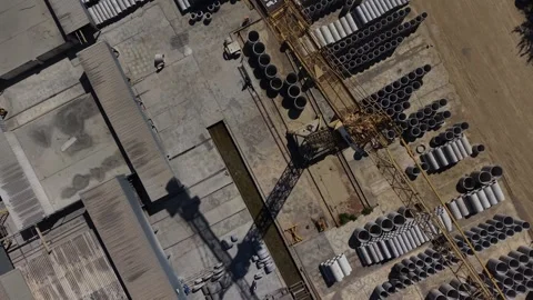 Top Down Aerial View of Industrial Crane and Concrete Pipes Video stock 342607181