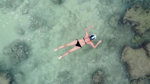 Top down aerial view of lady snorkeling or snorkelling 4k Stock Footage 266896183
