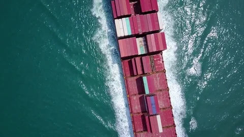 Top-down aerial view of large container ship sailing half-loaded Stock Footage 75991212