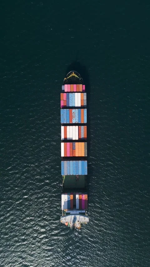 Top down aerial view of a large container ship in the deep blue ocean Stock Footage 333554473