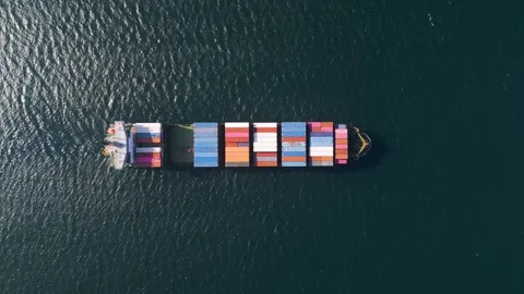 Top down aerial view of a large container ship in the deep blue ocean Stock Footage 333554487