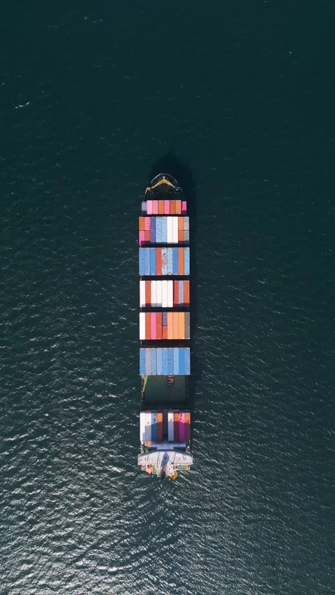 Top down aerial view of a large container ship in the deep blue ocean Stock Footage 333554488