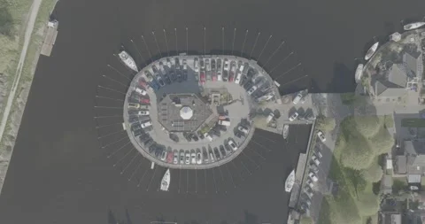 Top down aerial view of a leisure yacht boat dock, in round pattern in DLOG Stock Footage 240328476