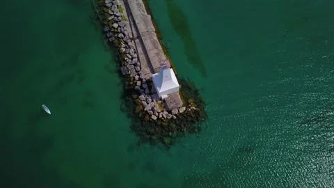 Top down aerial view of a lighthouse and kayak Stock Footage 135475914