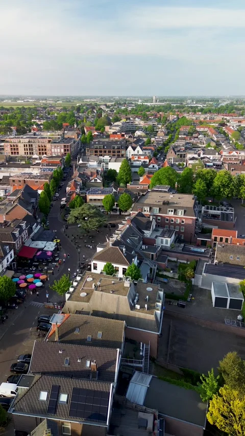 Top-down aerial view of a lively European street scene with colorful umbrellas Stock Footage 316584755