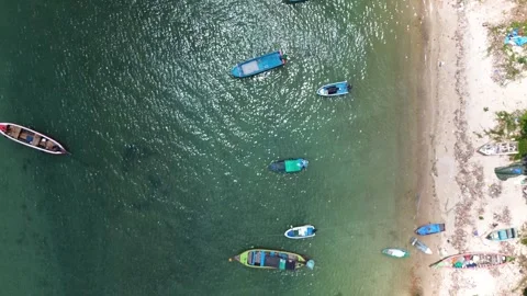 Top down aerial view of longtail boats on turquoise water near beach in Patong 動画素材 332711566