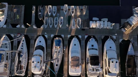 Top down aerial view of luxury yachts docked in marina harbor geometric pattern Stock Footage 333205339