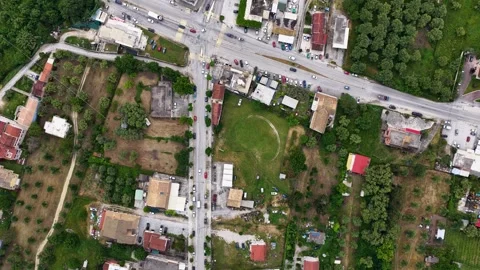 Top down aerial view of the main crossroads intersection in Roda village, North Stock Footage 335166864