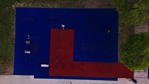 Top down aerial view of man training at outdoor gym Stock Footage 332867403