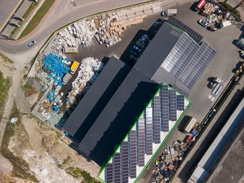 Top down aerial view of modern eco recycling factory with solar panels on roo Fotos Stock