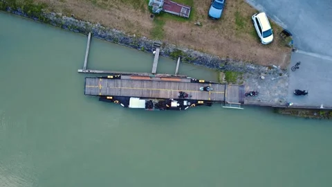 Top down aerial view of motorcyclists leaving a small ferry on the Danube Video stock 342426772